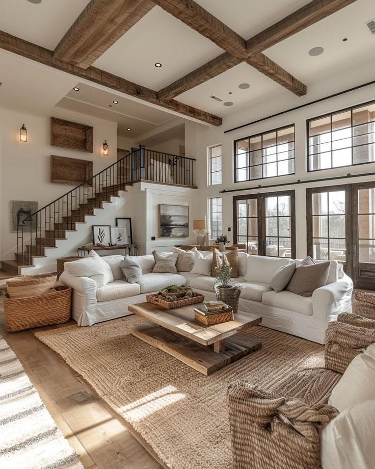 Living beamed ceiling white interior of a custom home by Hand Made Enterprises