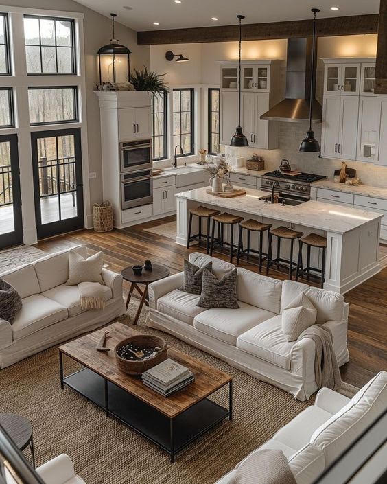 Open kitchen living white interior of a custom home by Hand Made Enterprises