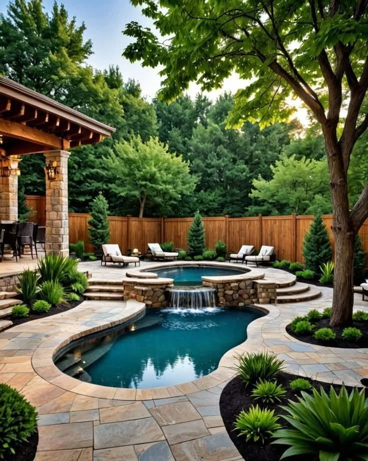 A pool with a stone spa spillover and a flagstone patio